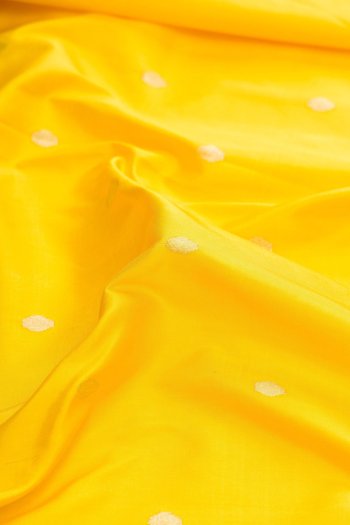 Close up of Pure Silk Pure Zari Yellow Dual Tone Paithani Saree with Zari Butta on the body and Paithani Border.  displaying folds