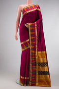 Burgundy Dual Tone Kanchipuram Silk Saree with Zari Butta on the body and Temple Border.  displayed on a mannequin