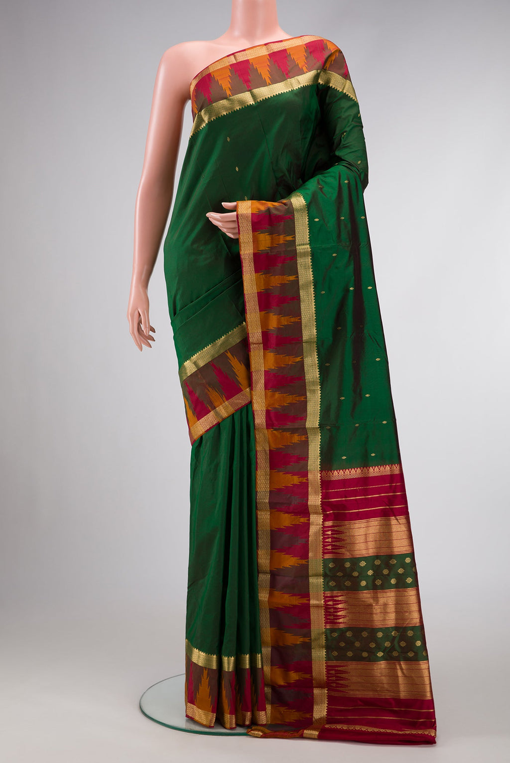 Green Dual Tone Kanchipuram Silk Saree with Zari Butta on the body and Temple Border.  displayed on a mannequin