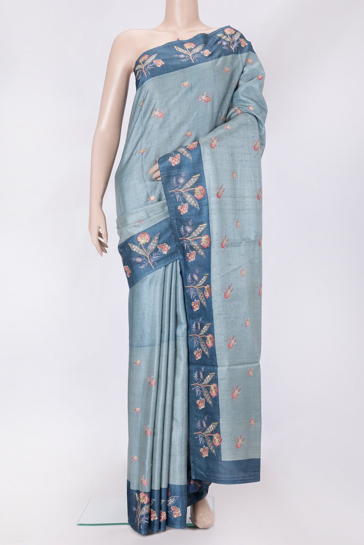 Grey Dual Tone Tussar Silk Saree with Thread Butta on the body and Embroidery Border.  displayed on a mannequin