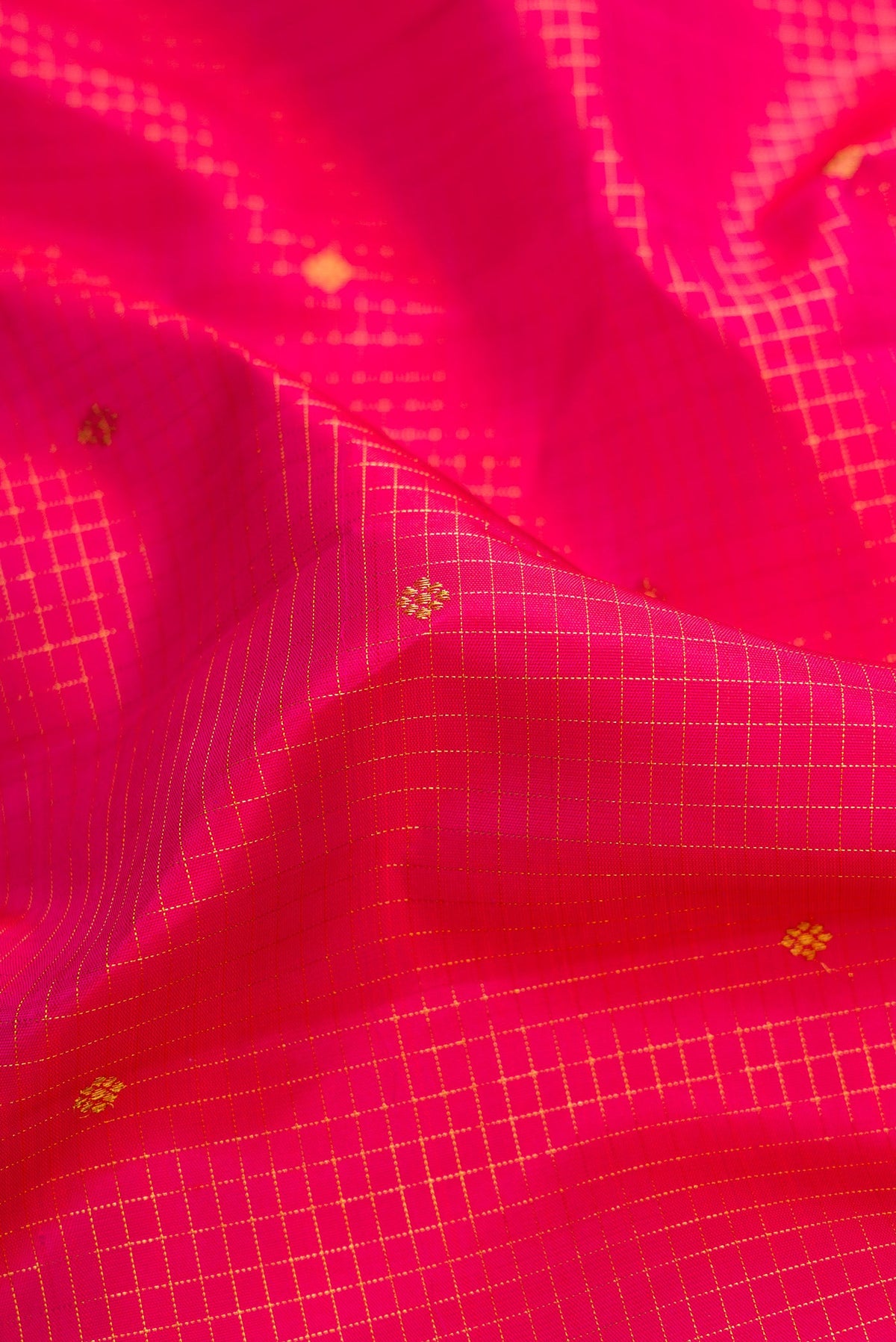 Close up of Pure Silk Pure Zari Dark Pink Dual Tone Kanchipuram Saree with Stripes on the body and Zari Border.  displaying folds