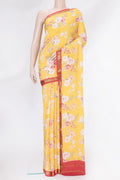 Yellow Mysore Crepe Saree with Floral Print on the body and Zari Border.  displayed on a mannequin