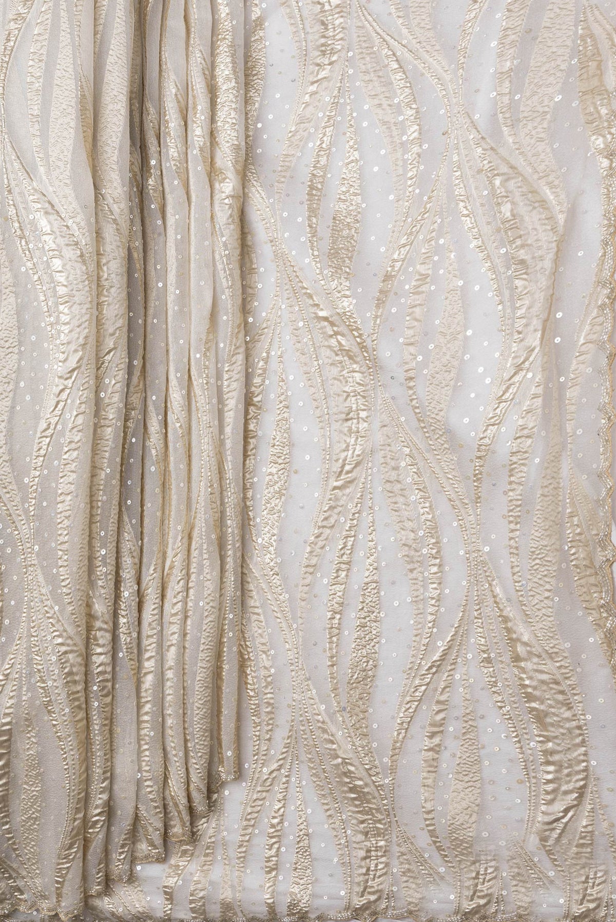 Pleats and pallu of Gold Dual Tone Organza Silk Saree with Embroidery on the body and Embroidery Border. 