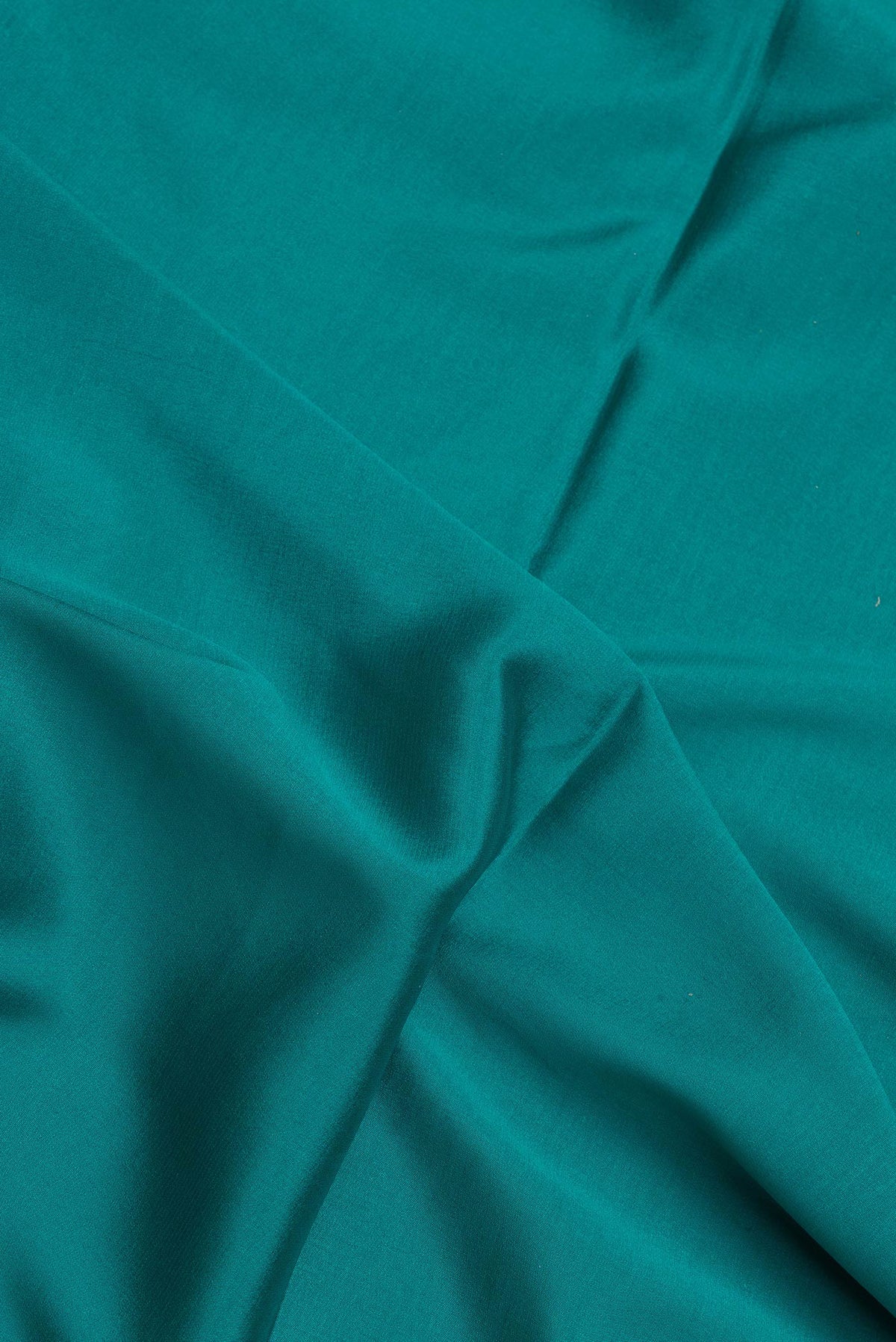 Close up of Sky Blue Dual Tone Mysore Silk Saree with Plain Body and Fancy Border.  displaying folds
