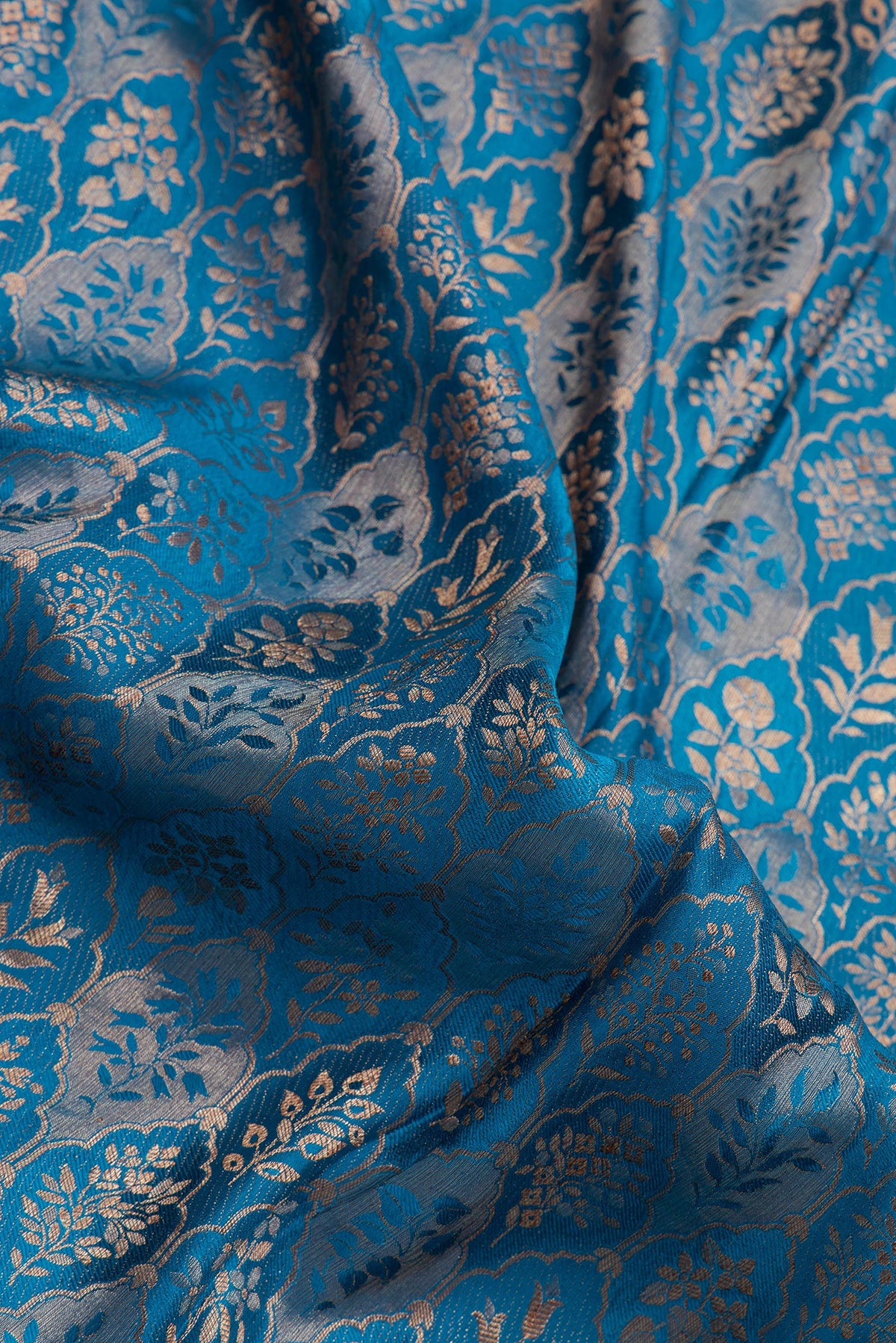 Close up of Peacock Blue Mysore Crepe Saree with Zari Brocade on the body and Zari Border.  displaying folds