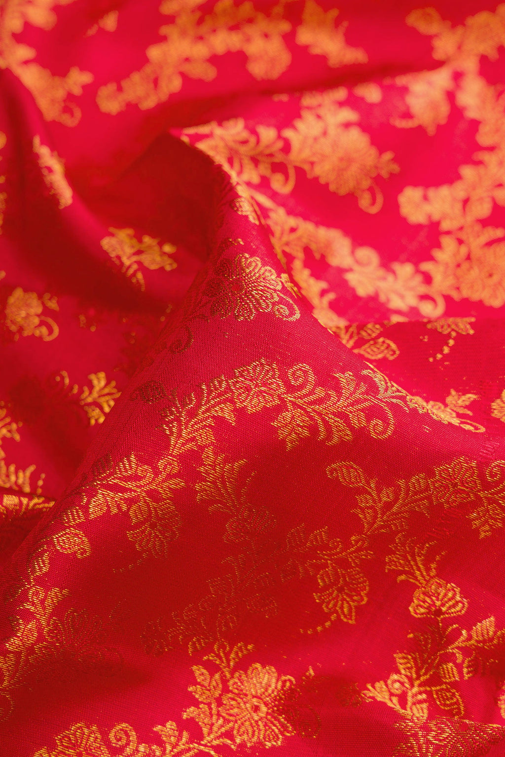 Close up of Red Dual Tone Kanjivaram Silk Saree with Zari Brocade on the body and Zari Border.  displaying folds