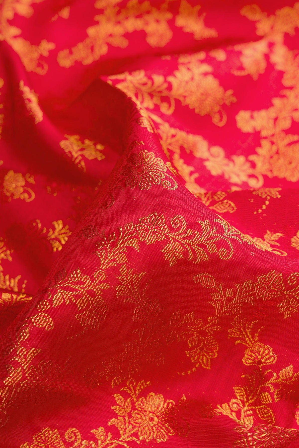 Close up of Red Dual Tone Kanjivaram Silk Saree with Zari Brocade on the body and Zari Border.  displaying folds