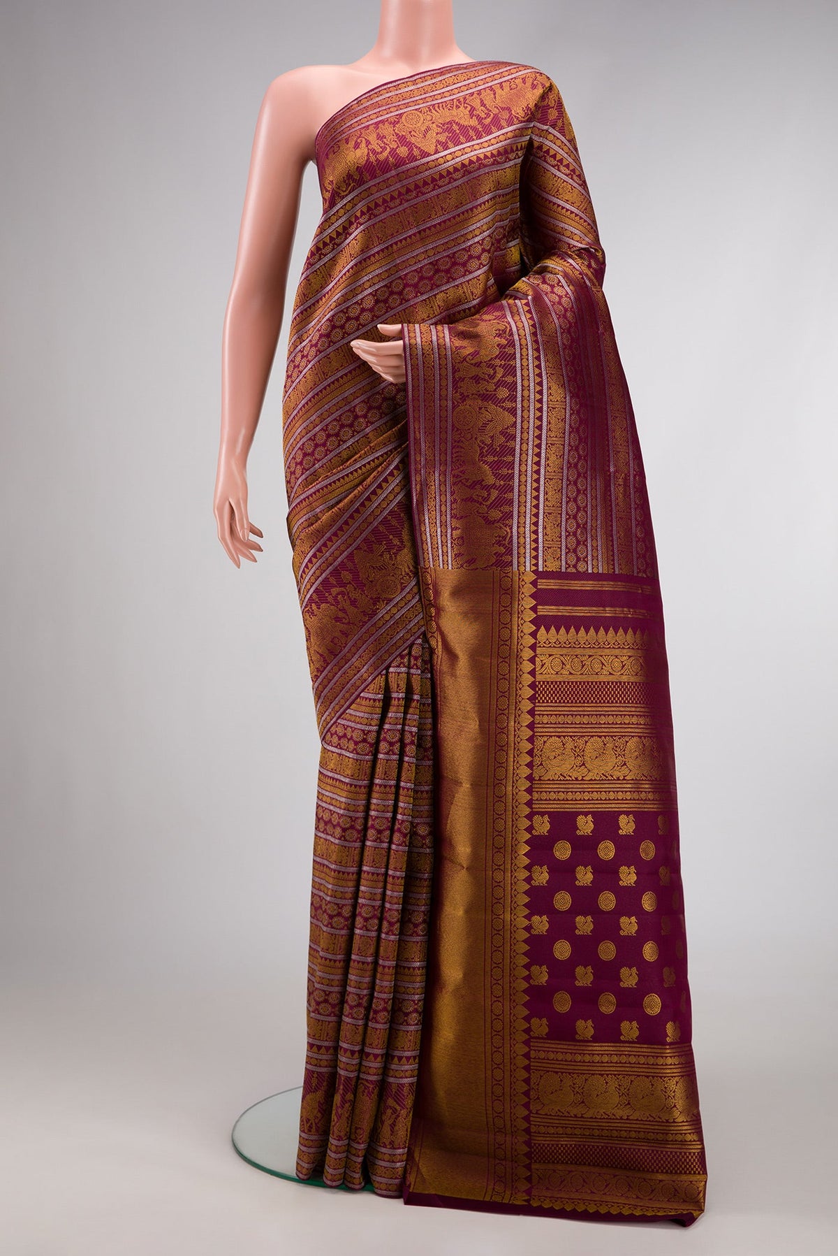 Burgundy Dual Tone Kanchipuram Silk Saree with Zari Brocade on the body and Zari Border.  displayed on a mannequin