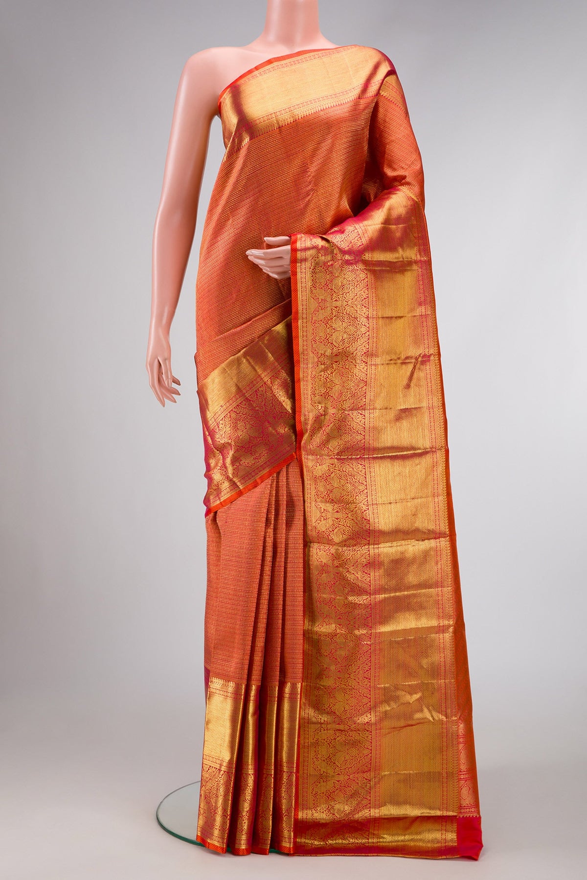Coral Dual Tone Kanchipuram Silk Saree with Zari Brocade on the body and Zari Border.  displayed on a mannequin