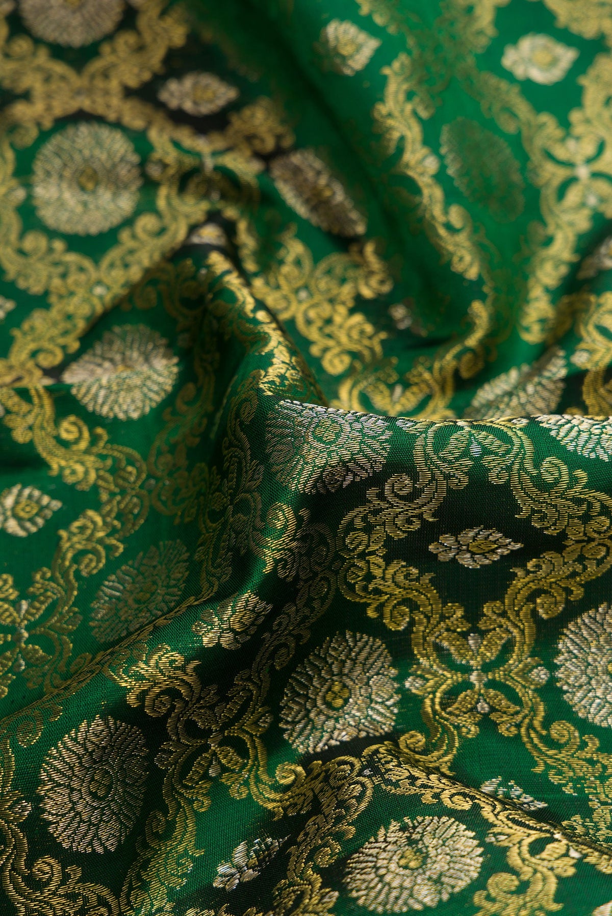 Close up of Green Dual Tone Kanchipuram Silk Saree with Zari Brocade on the body and Zari Border.  displaying folds