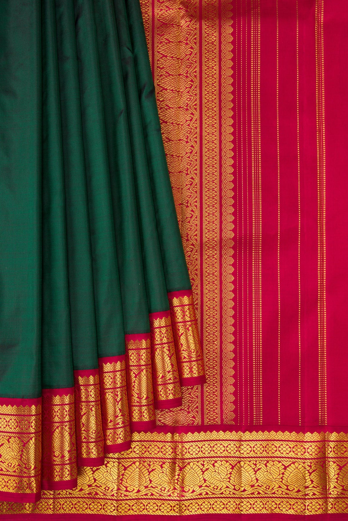 Pleats and pallu of Bottle Green Kanjivaram Silk Saree with Plain Body and Zari Border. 
