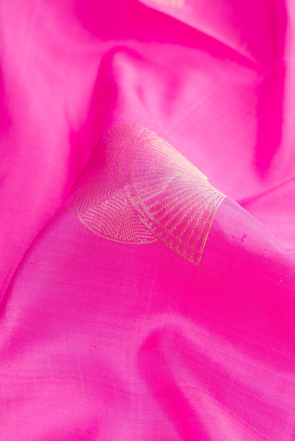 Close up of Pink Dual Tone Soft Silk Saree with Zari Butta on the body and Zari Border.  displaying folds