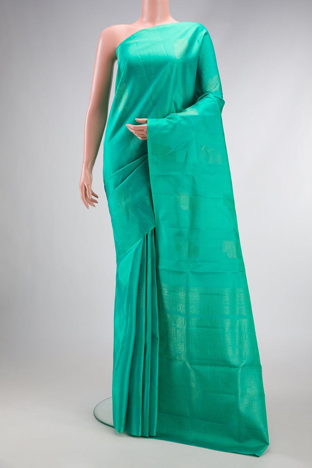 Sea Green Dual Tone Kanjivaram Silk Saree with Zari Butta on the body and Without Border.  displayed on a mannequin