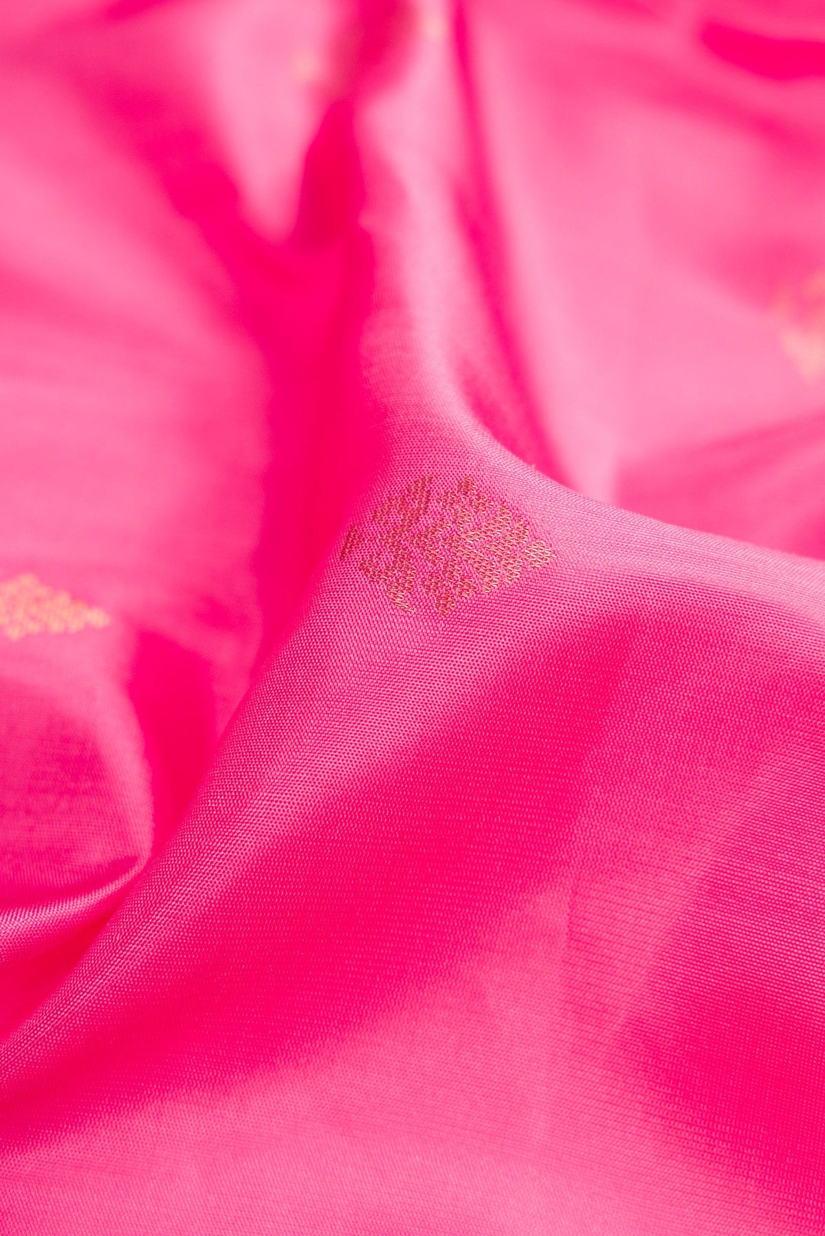 Close up of Pink Dual Tone Soft Silk Saree with Zari Butta on the body and Zari Border.  displaying folds