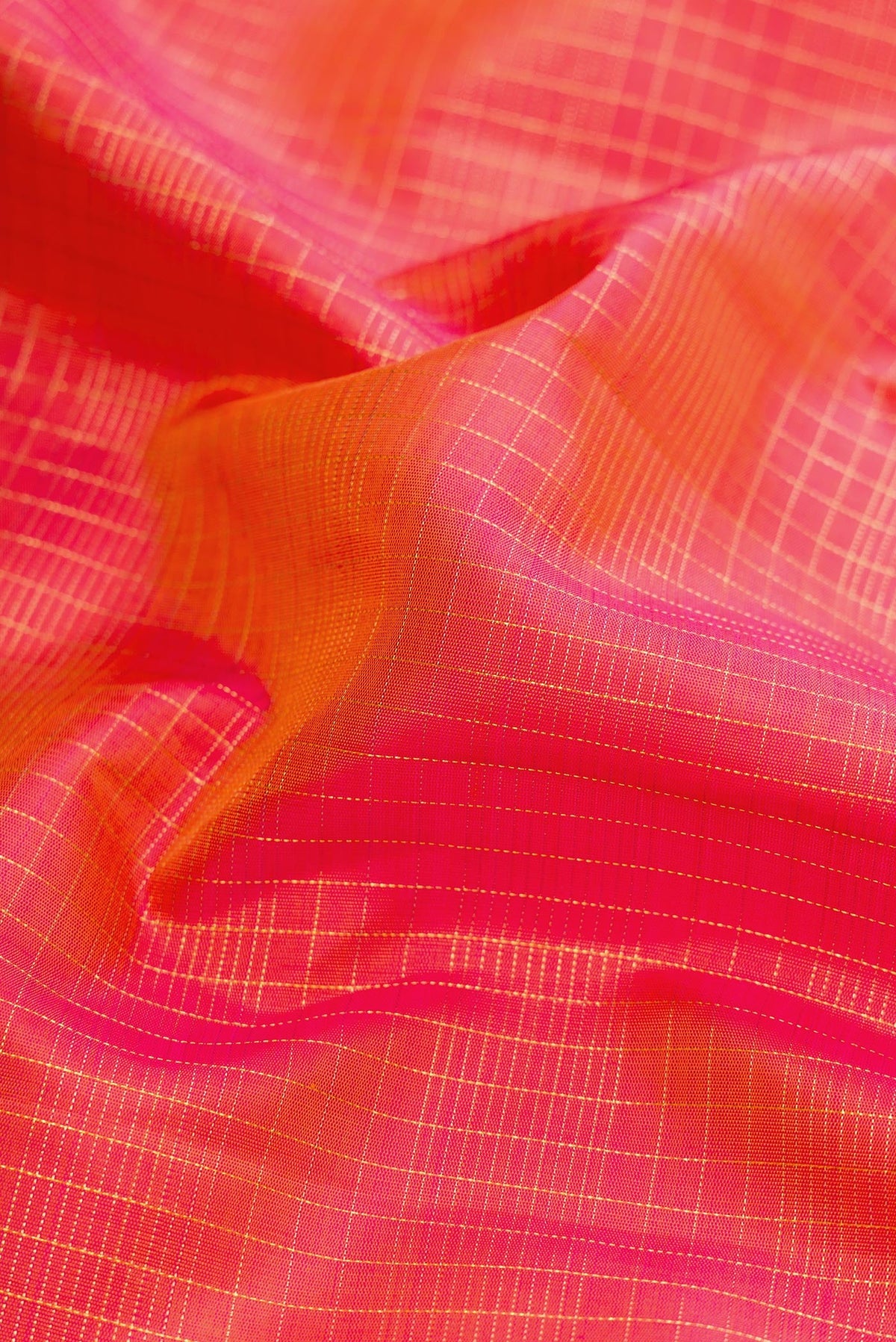 Close up of Pure Silk Pure Zari Coral Dual Tone Kanchipuram Nine Yards Saree with Checked design on the body and Zari Border.  displaying folds
