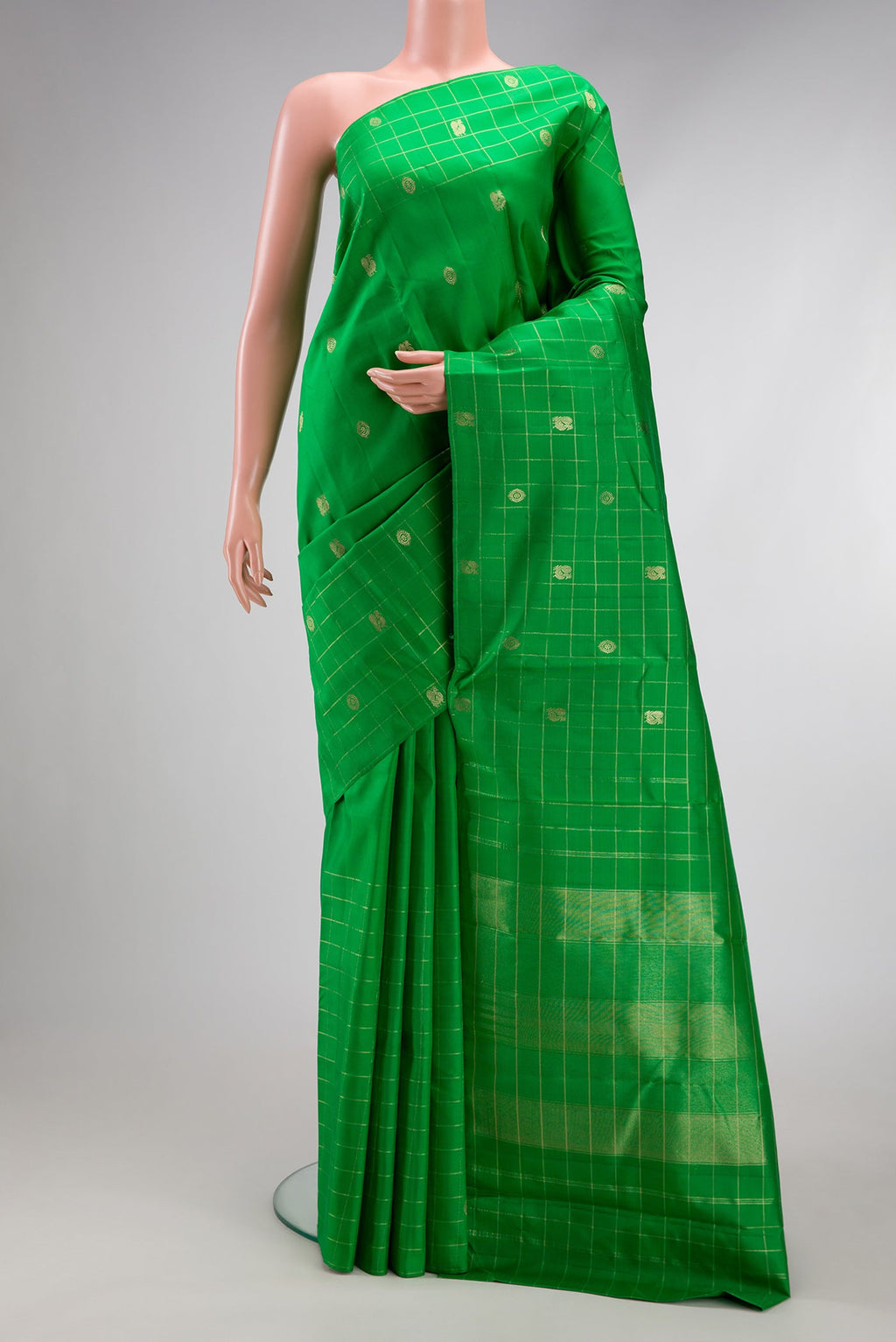 Green Kanchipuram Silk Saree with Zari Butta on the body and Checks Border.  displayed on a mannequin