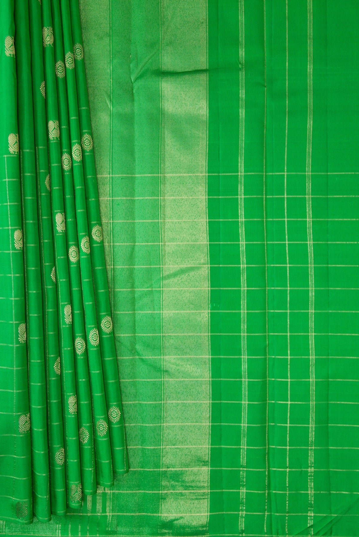 Pleats and pallu of Green Kanchipuram Silk Saree with Zari Butta on the body and Checks Border. 