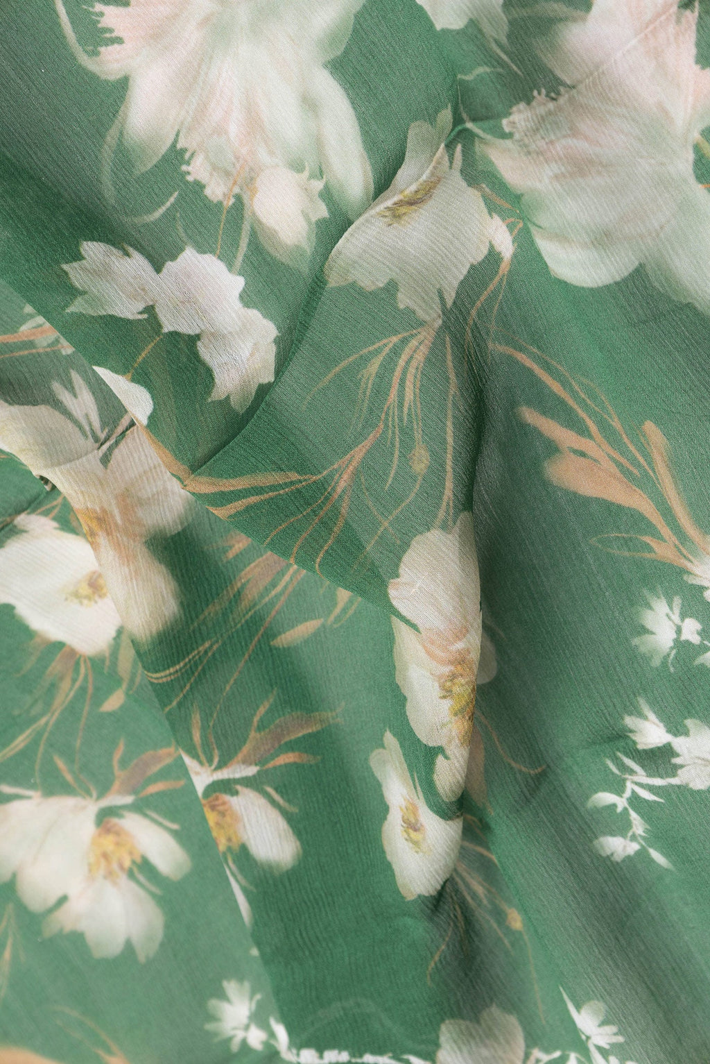 Close up of Green Dual Tone Mysore Chiffon Saree with Printed design on the body and Zari Border.  displaying folds
