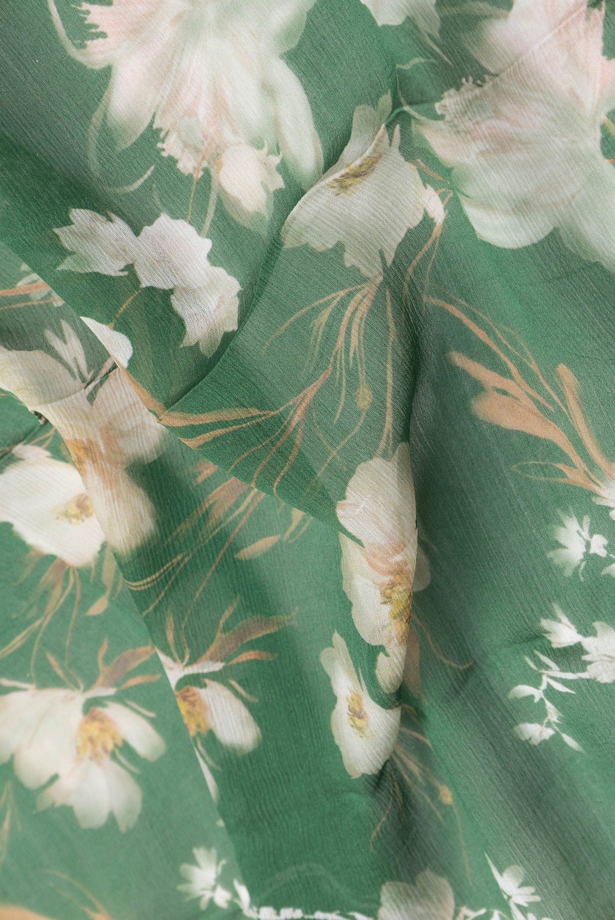 Close up of Green Dual Tone Mysore Chiffon Saree with Printed design on the body and Zari Border.  displaying folds