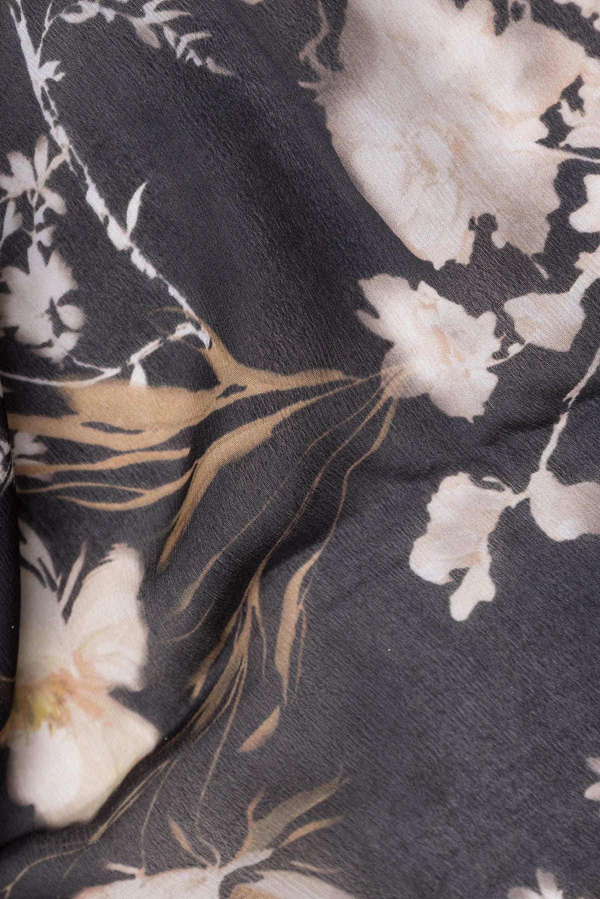 Close up of Black Mysore Chiffon Saree with Printed design on the body and Zari Border.  displaying folds