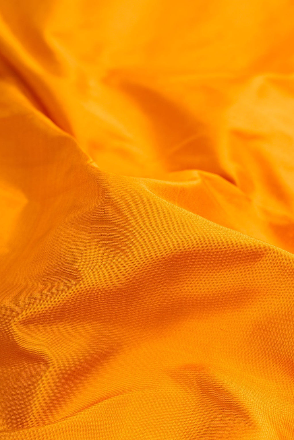 Close up of Pure Silk Pure Zari Mustard Dual Tone Kanchipuram Nine Yards Saree with Plain Body and Zari Border.  displaying folds