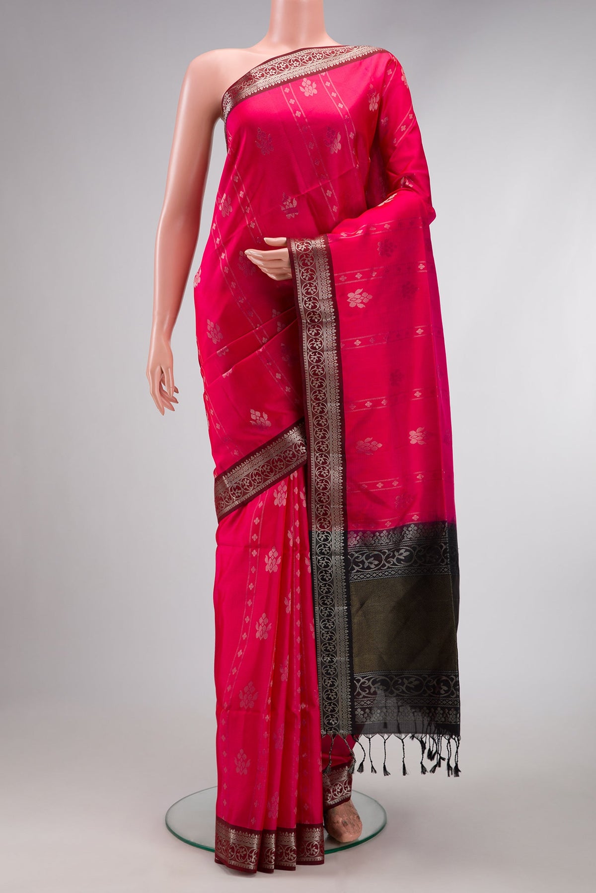 Pink Soft Silk Saree with Zari Butta on the body and Zari Border.  displayed on a mannequin