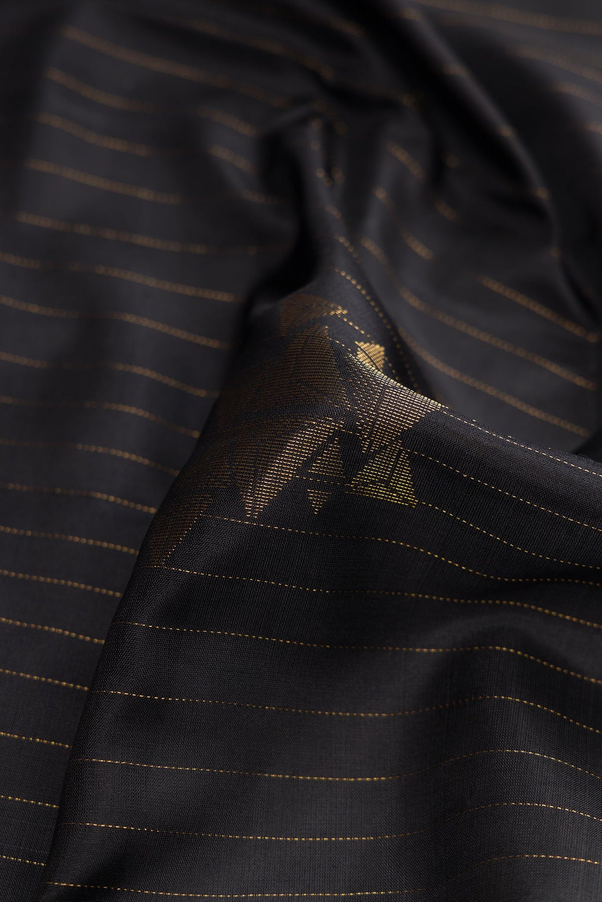 Close up of Black Dual Tone Soft Silk Saree with Stripes on the body and Zari Border.  displaying folds