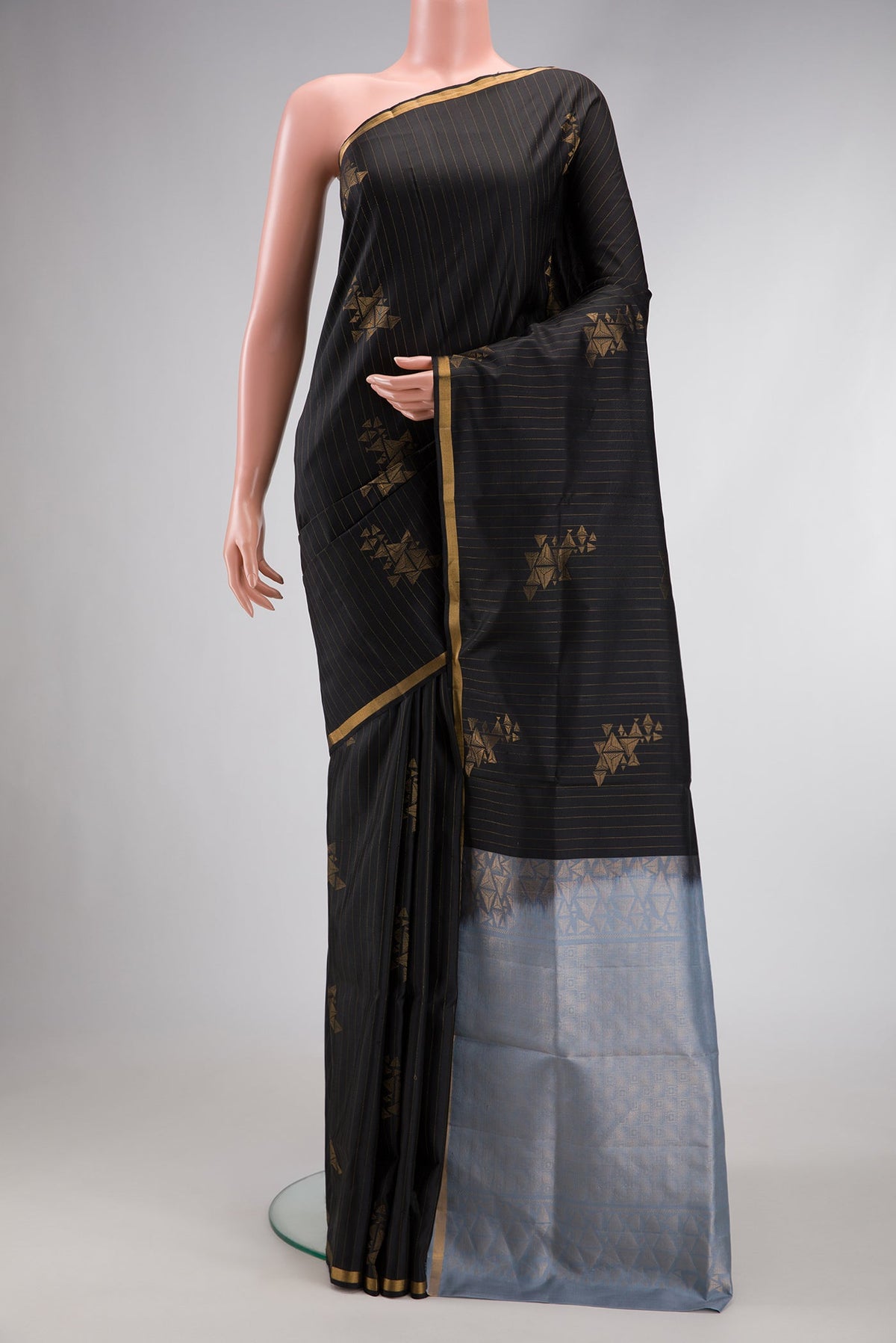 Black Dual Tone Soft Silk Saree with Stripes on the body and Zari Border.  displayed on a mannequin