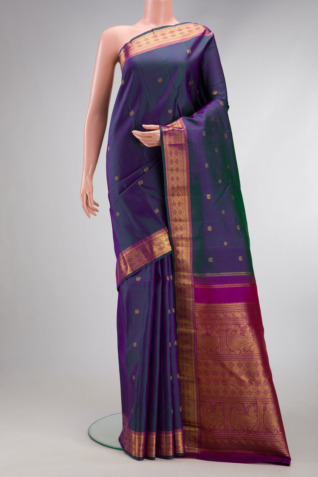 Peacock Blue Dual Tone Kanchipuram Silk Saree with Zari Butta on the body and Zari Border.  displayed on a mannequin