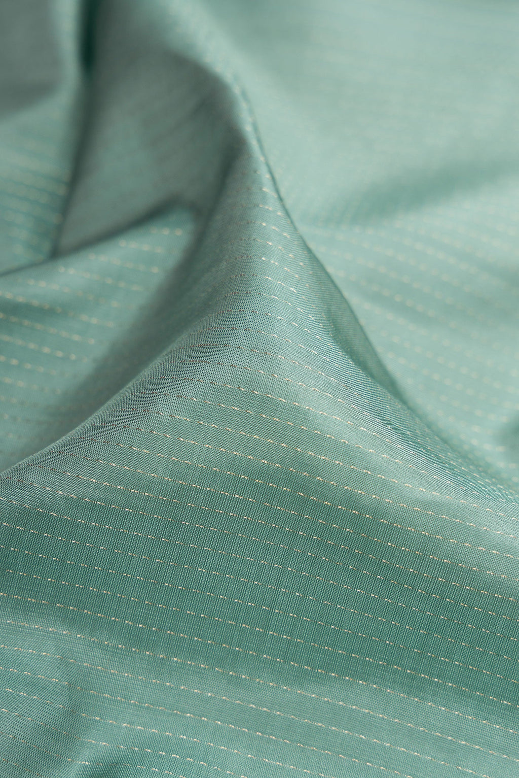 Close up of Grey Soft Silk Saree with Stripes on the body and Zari Border.  displaying folds