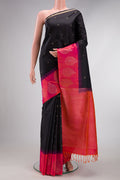 Black Soft Silk Saree with Zari Butta on the body and Fancy Border.  displayed on a mannequin