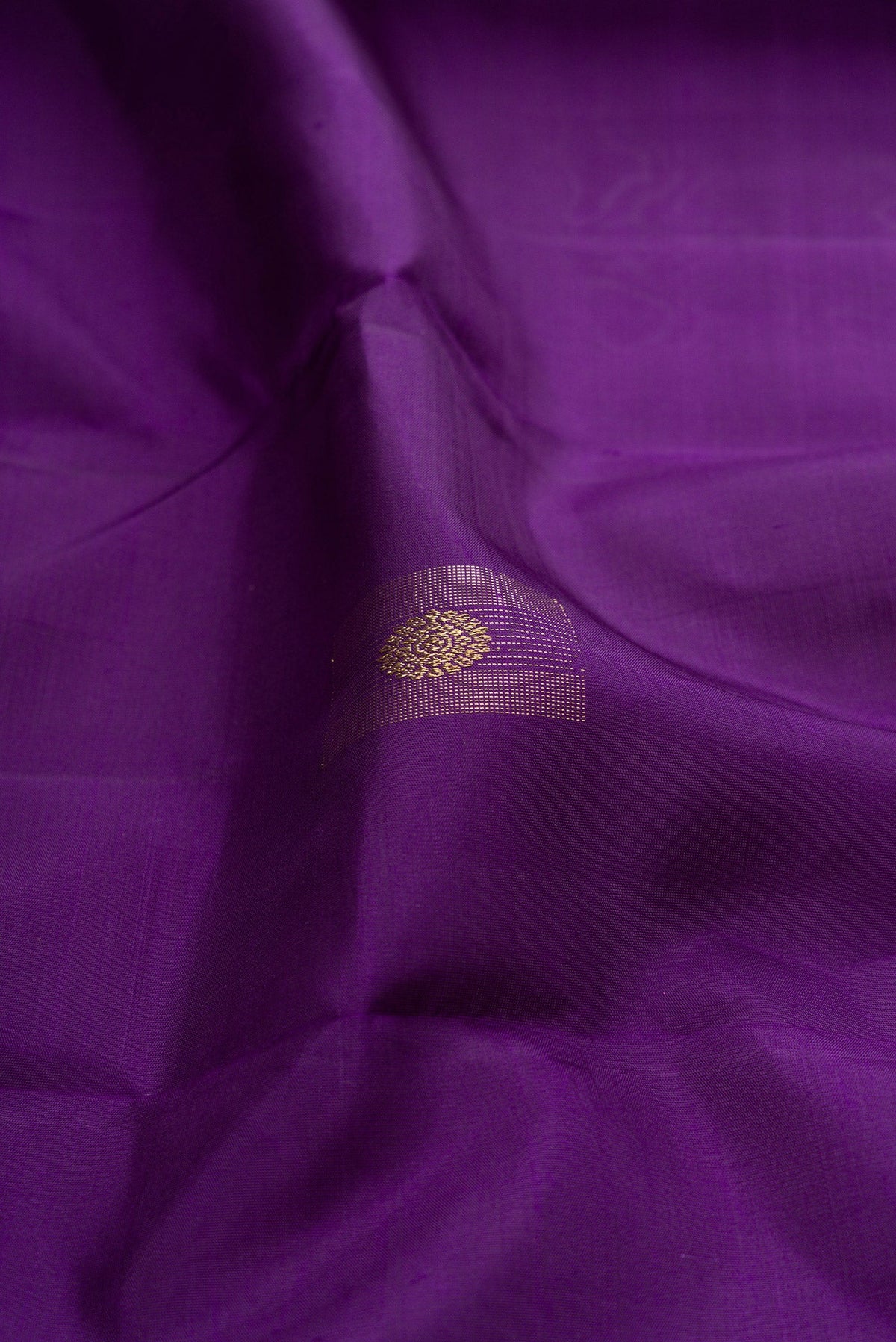 Close up of Pure Silk Pure Zari Violet Kanjivaram Saree with Zari Butta on the body and Without Border.  displaying folds
