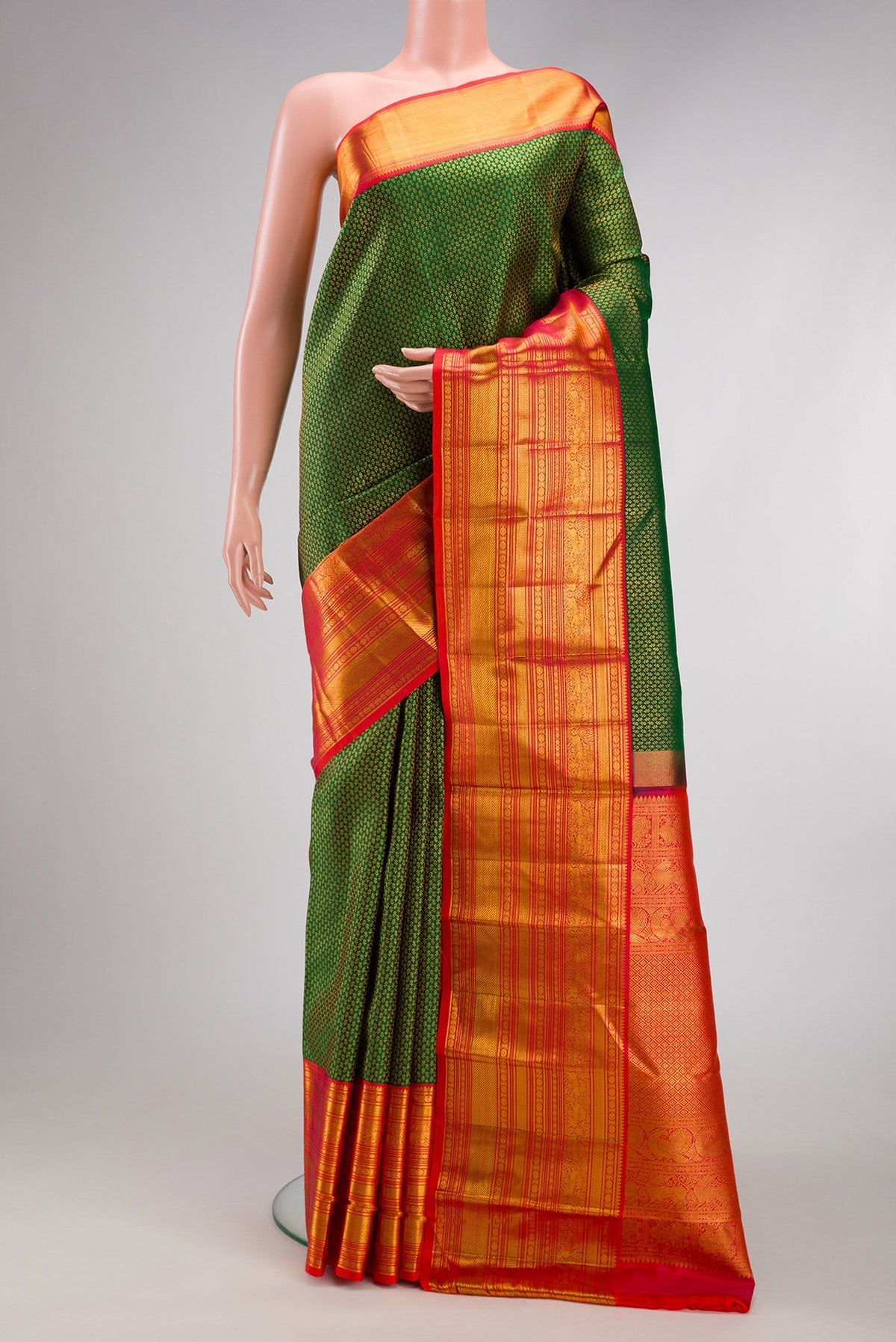 Green Kanjivaram Silk Saree with Zari Brocade on the body and Zari Border.  displayed on a mannequin