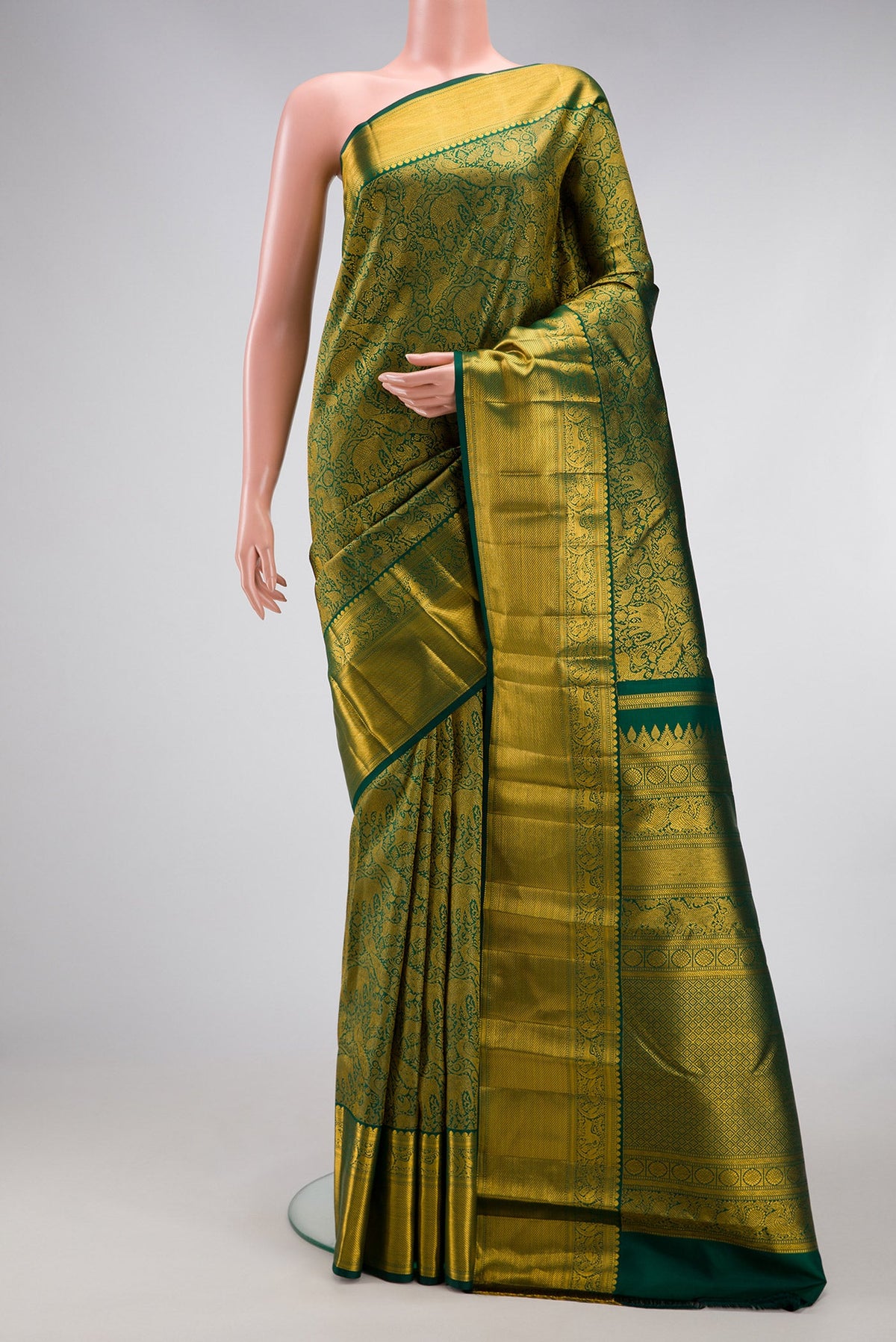 Green Kanjivaram Silk Saree with Zari Brocade on the body and Zari Border.  displayed on a mannequin