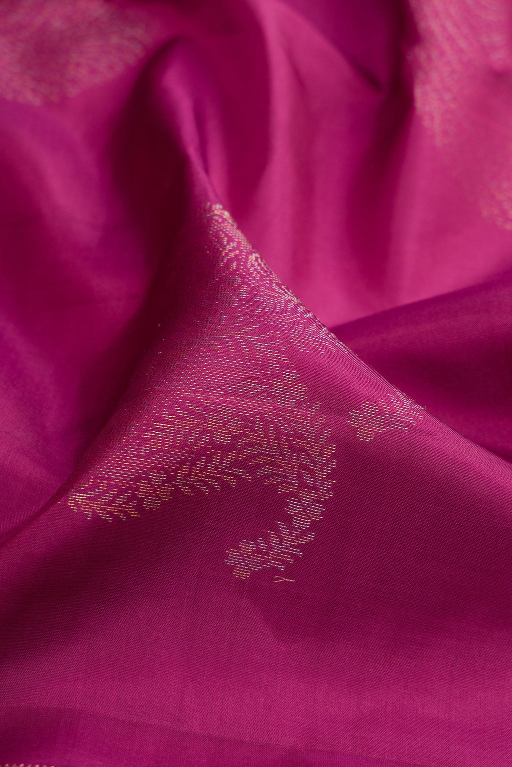 Close up of Magenta Soft Silk Saree with Zari Butta on the body and Without Border.  displaying folds