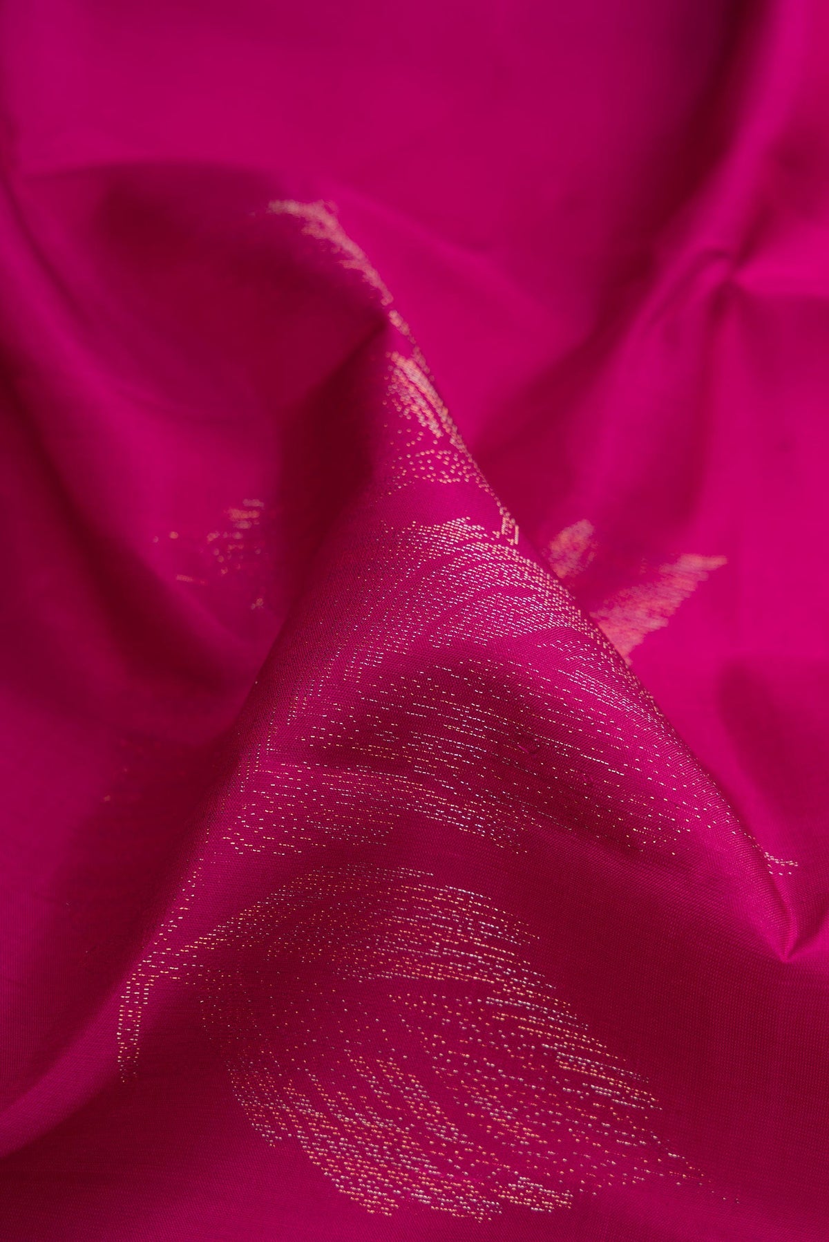 Close up of Magenta Soft Silk Saree with Zari Butta on the body and Without Border.  displaying folds