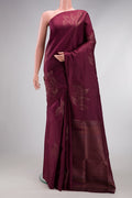 Burgundy Soft Silk Saree with Zari Butta on the body and Without Border.  displayed on a mannequin