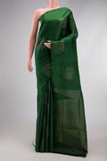 Bottle Green Soft Silk Saree with Zari Butta on the body and Without Border.  displayed on a mannequin