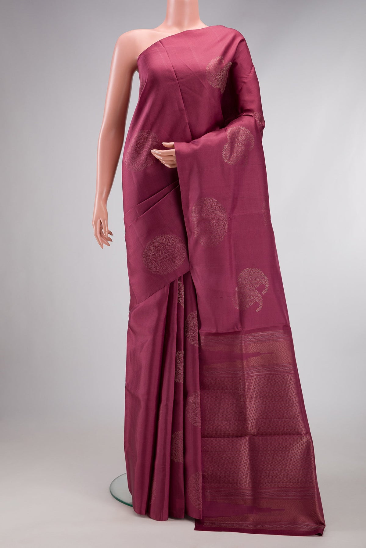 Mauve Soft Silk Saree with Zari Butta on the body and Without Border.  displayed on a mannequin