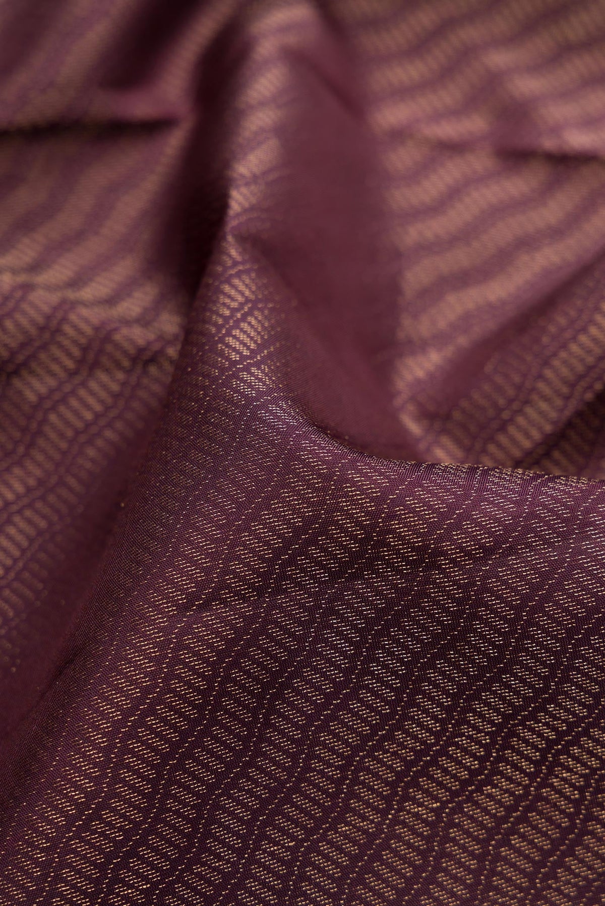 Close up of Burgundy Dual Tone Soft Silk Saree with Zari Brocade on the body and Fancy Border.  displaying folds