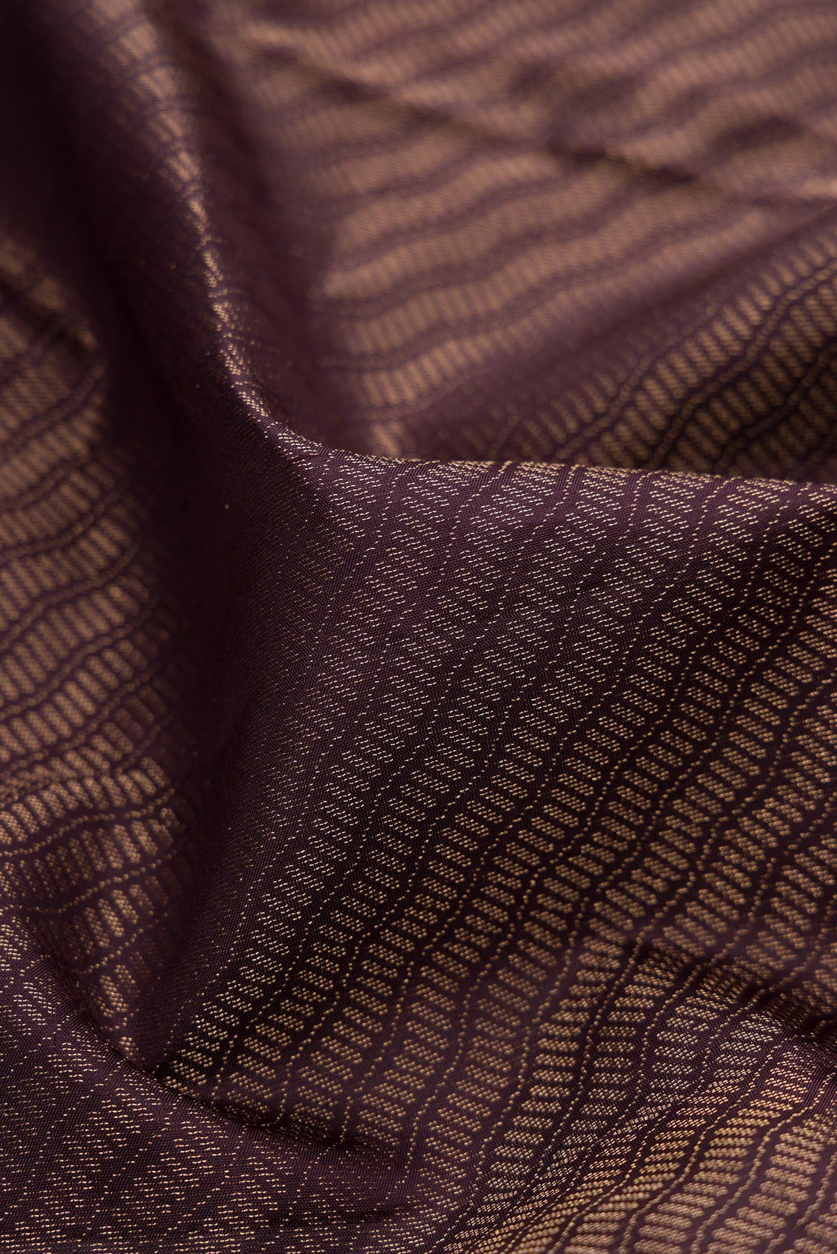 Close up of Burgundy Soft Silk Saree with Zari Brocade on the body and Fancy Border.  displaying folds