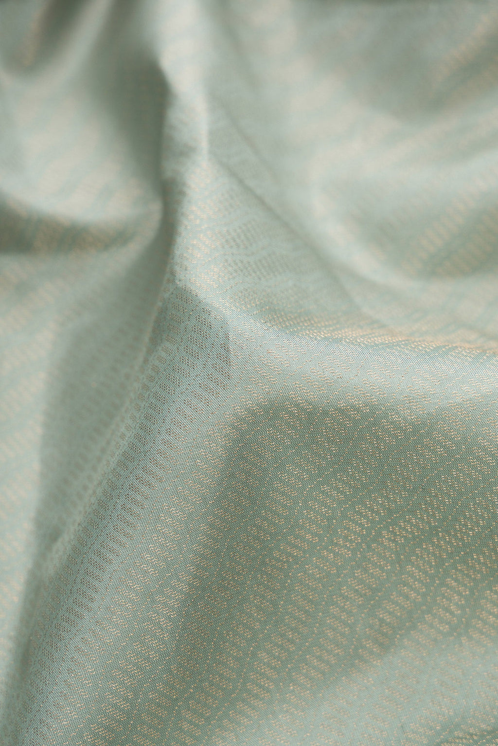 Close up of Light Blue Dual Tone Soft Silk Saree with Zari Brocade on the body and Fancy Border.  displaying folds
