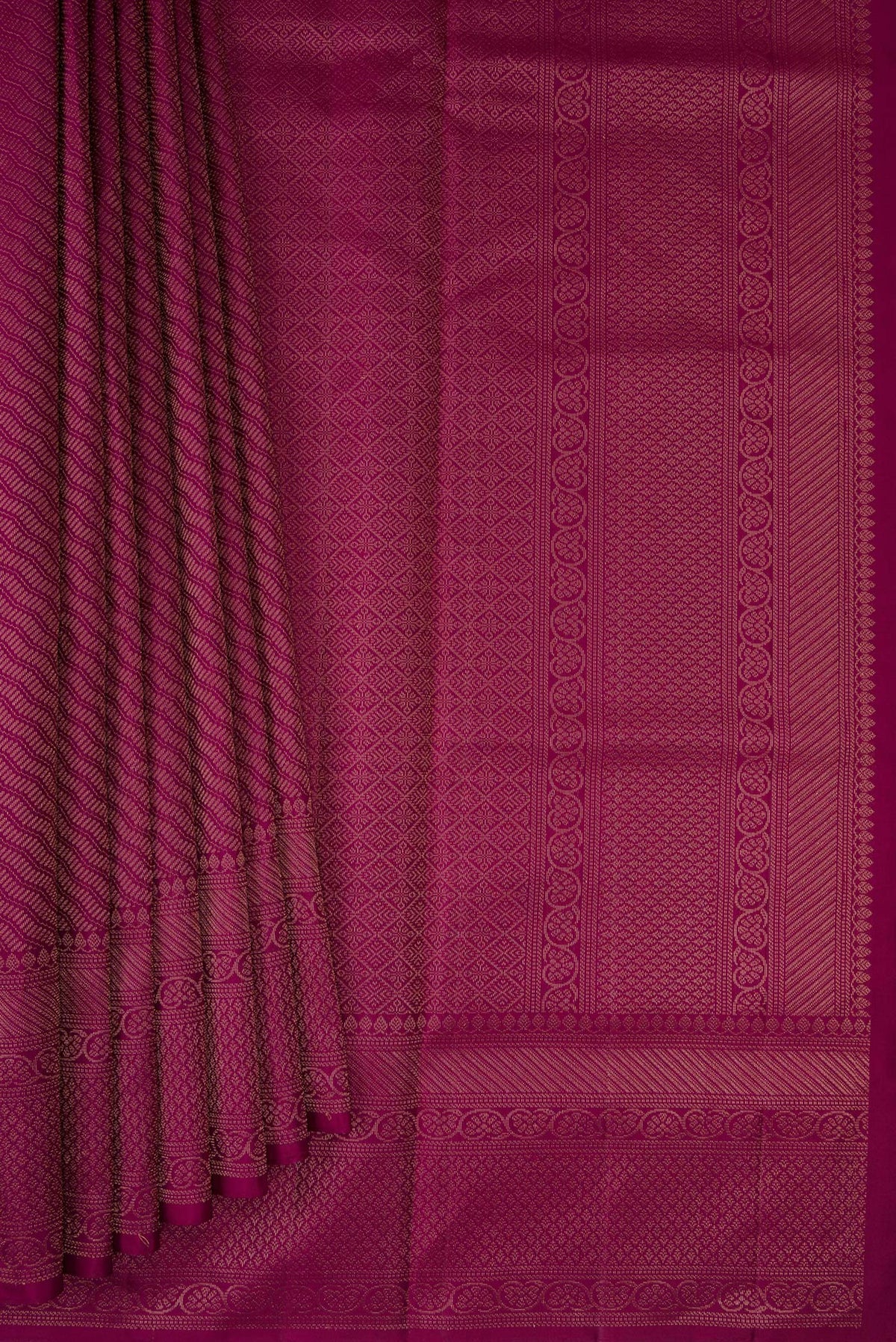 Pleats and pallu of Magenta Soft Silk Saree with Zari Brocade on the body and Fancy Border. 