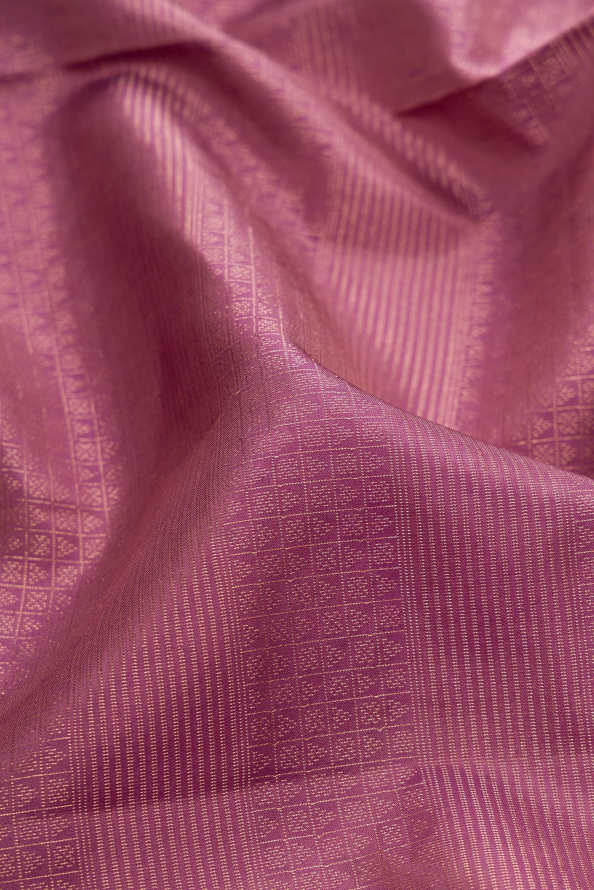 Close up of Purple Soft Silk Saree with Zari Brocade on the body and Fancy Border.  displaying folds