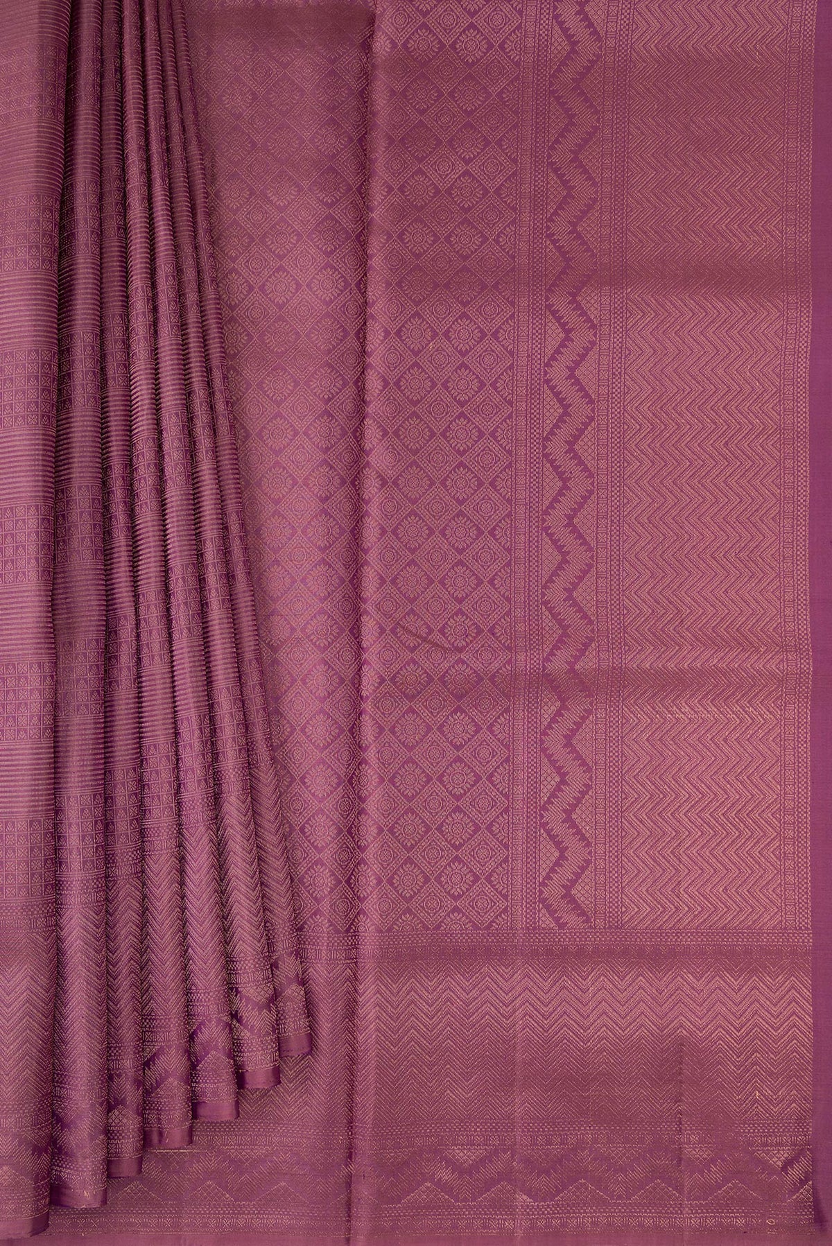 Pleats and pallu of Purple Soft Silk Saree with Zari Brocade on the body and Fancy Border. 