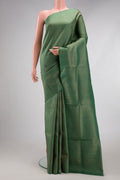 Green Soft Silk Saree with Zari Brocade on the body and Fancy Border.  displayed on a mannequin