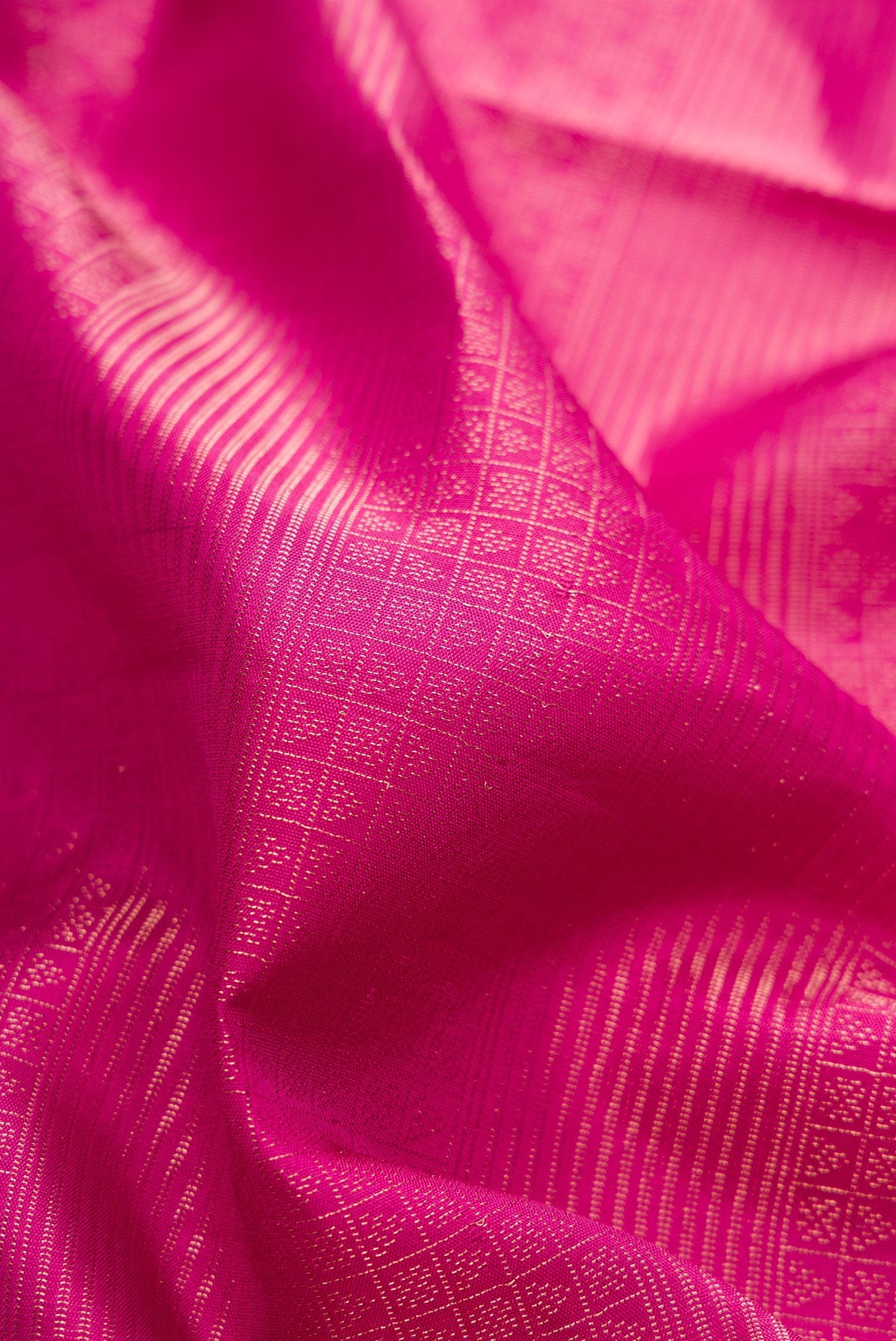 Close up of Magenta Soft Silk Saree with Zari Brocade on the body and Fancy Border.  displaying folds