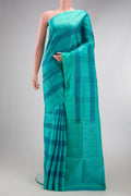 Sea Green Soft Silk Saree with Checked design on the body and Plain Border.  displayed on a mannequin