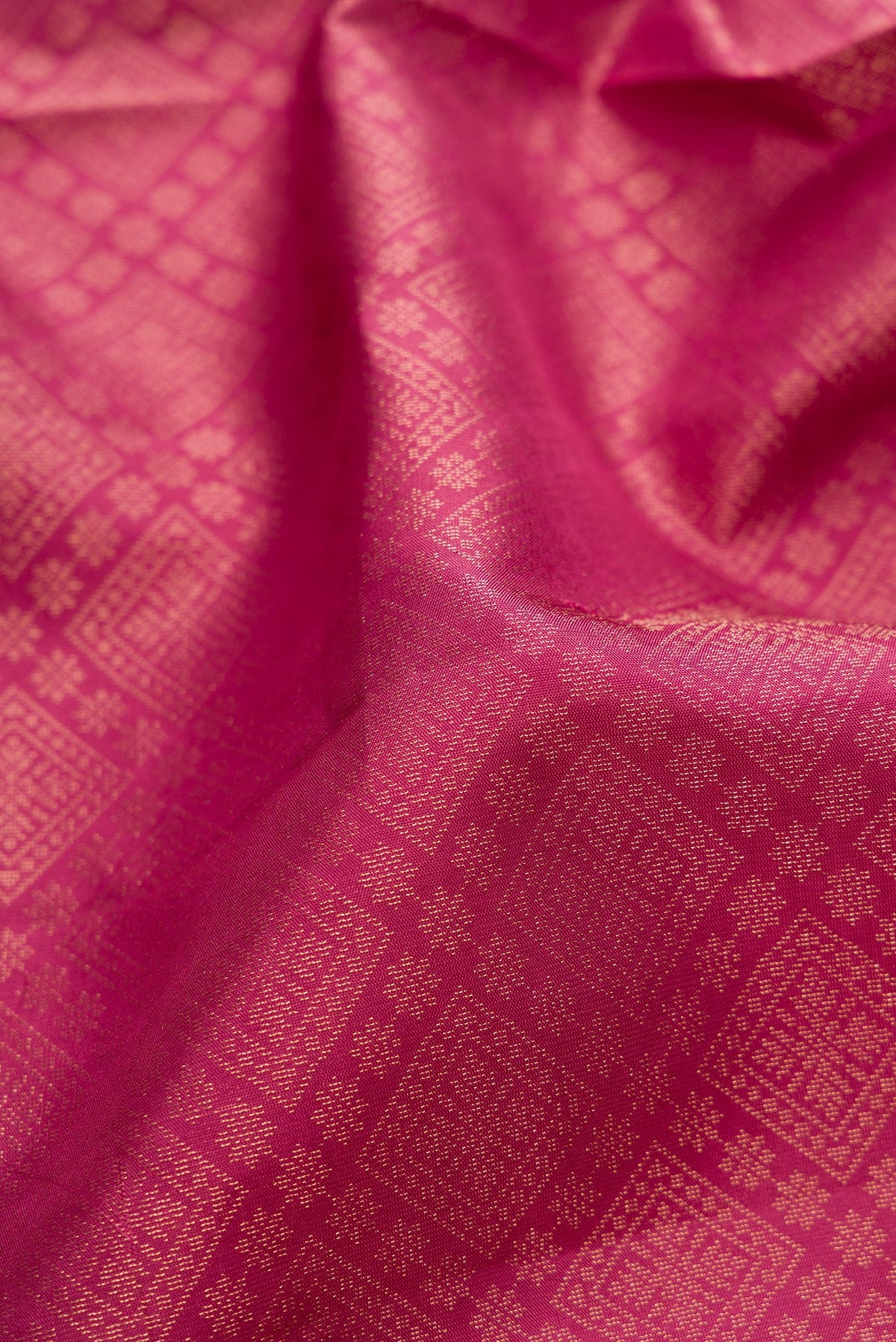 Close up of Pink Soft Silk Saree with Zari Brocade on the body and Fancy Border.  displaying folds