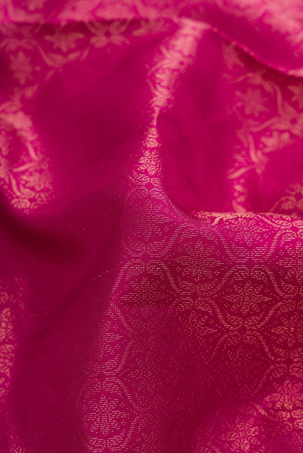 Close up of Magenta Soft Silk Saree with Zari Brocade on the body and Fancy Border.  displaying folds